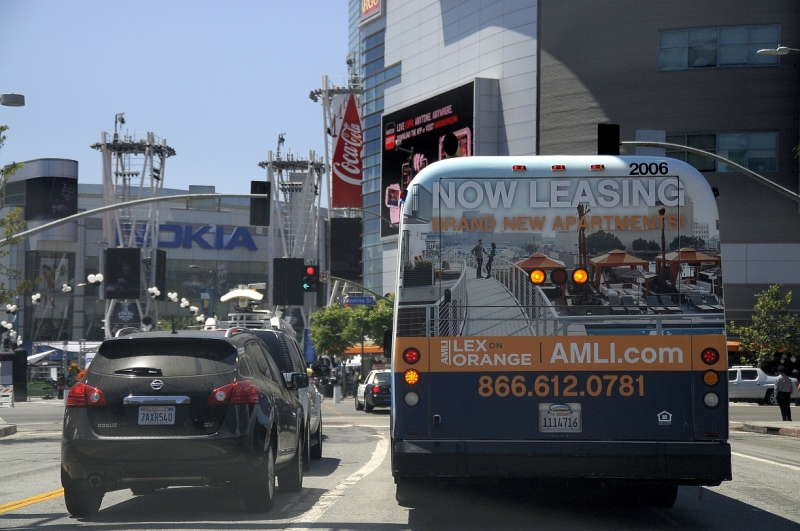 Los Angeles Downtown Bus Tail Fullback Billboard Ad for AMLI Lex on Orange as it drives by the Los Angeles Convention Center / LA Live / The Nokia Theatre